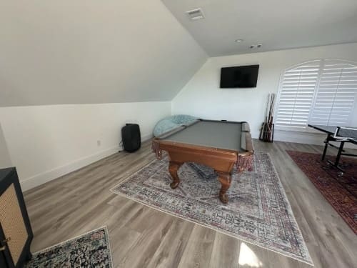A billiard table in a room with a couch in Liberty Hills, TX<br />
