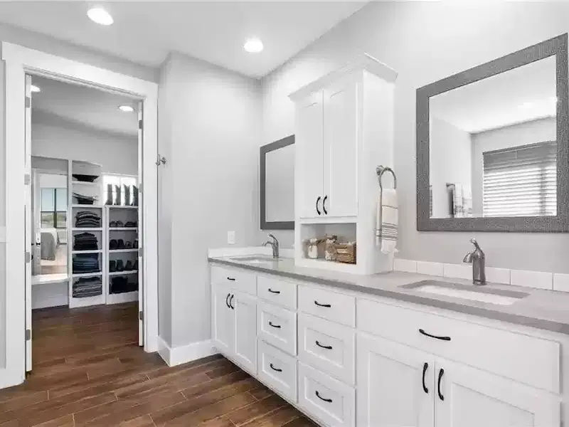 Spacious bathroom with double vanity and walk-in closet in a renovated Austin, TX home<br />
