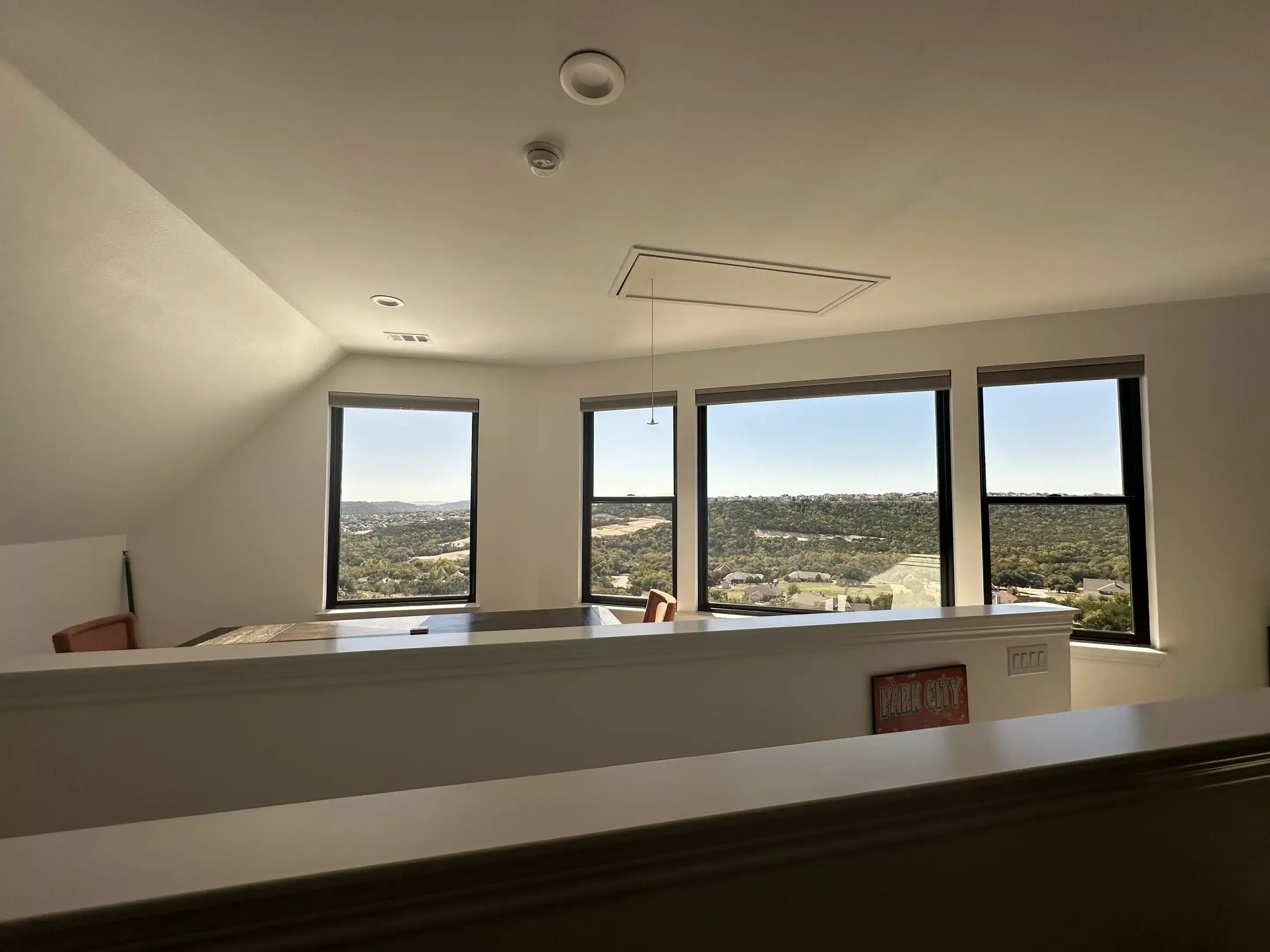 Bright upstairs living space with large windows overlooking hills in Austin, TX<br />
